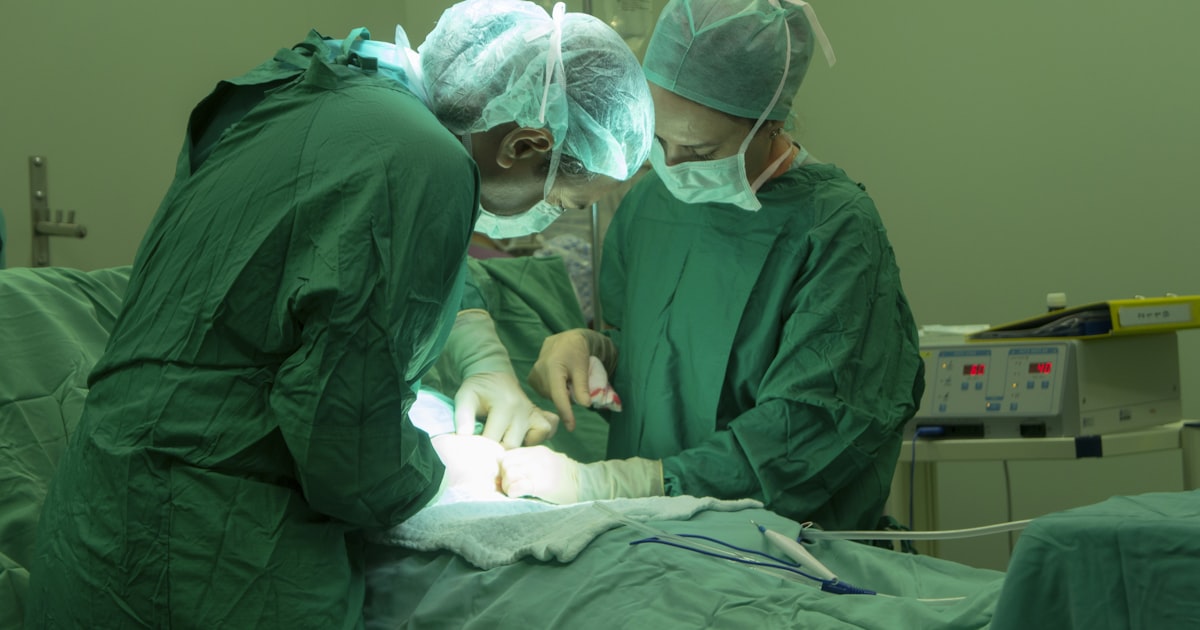 Surgical team in operating room with monitoring equipment