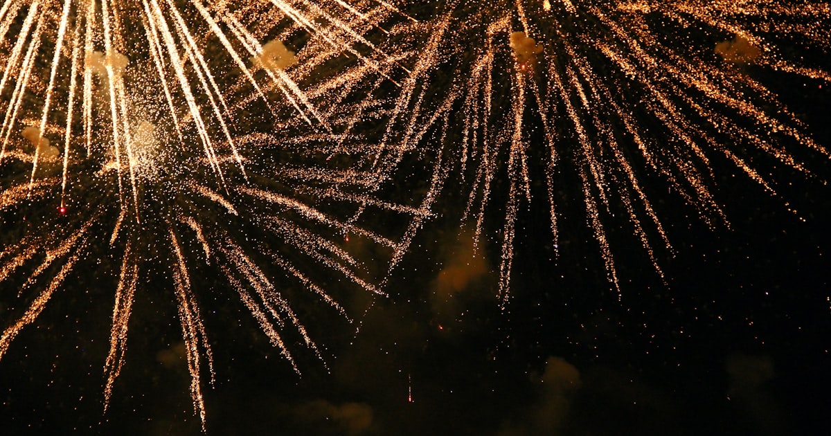 Close view of sparks and burning fuses from consumer fireworks