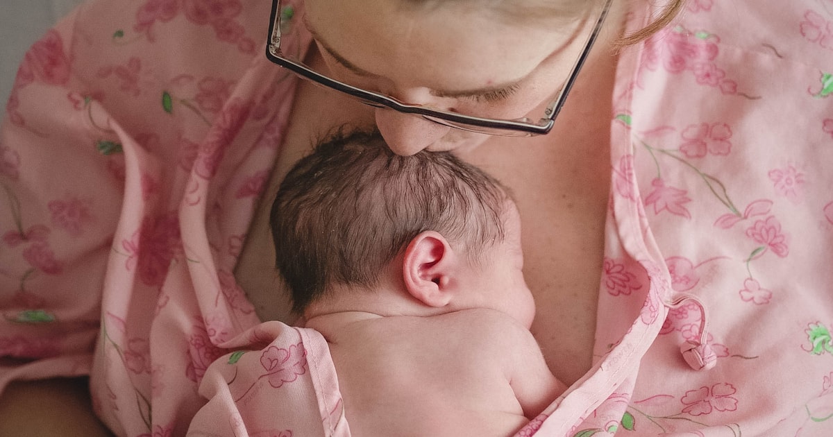 Newborn infant resting in a hospital bassinet after delivery