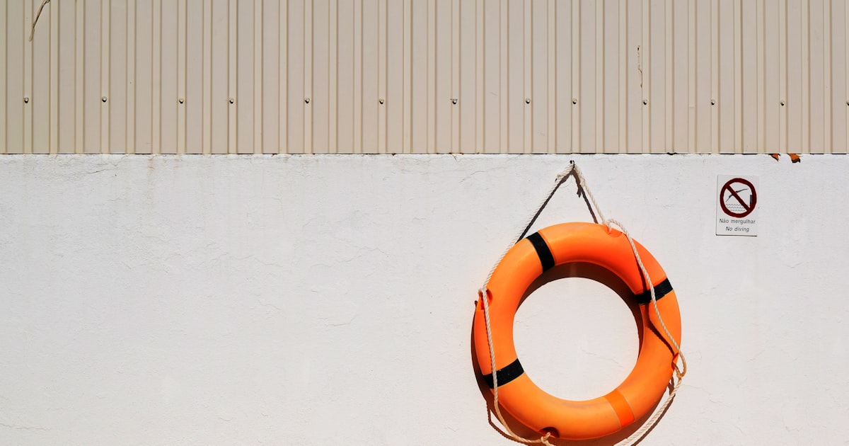 Pool safety fence with a self latching gate at a residential swimming pool