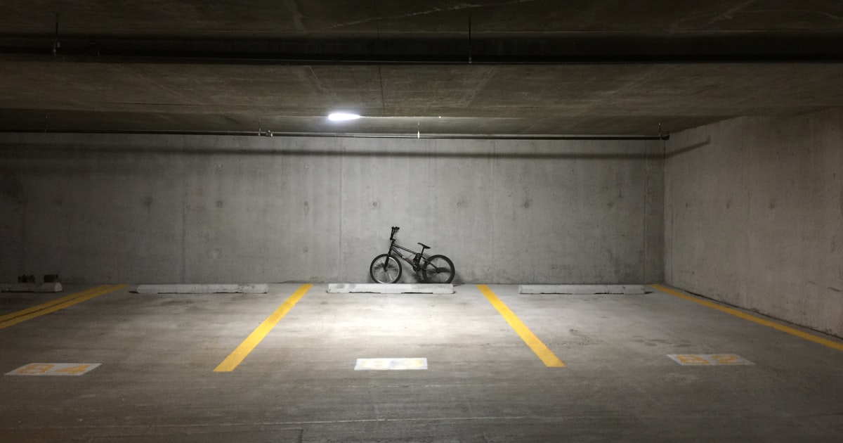 A dimly lit parking garage stairwell at night, the kind of location where inadequate lighting can support an Ohio negligent security claim