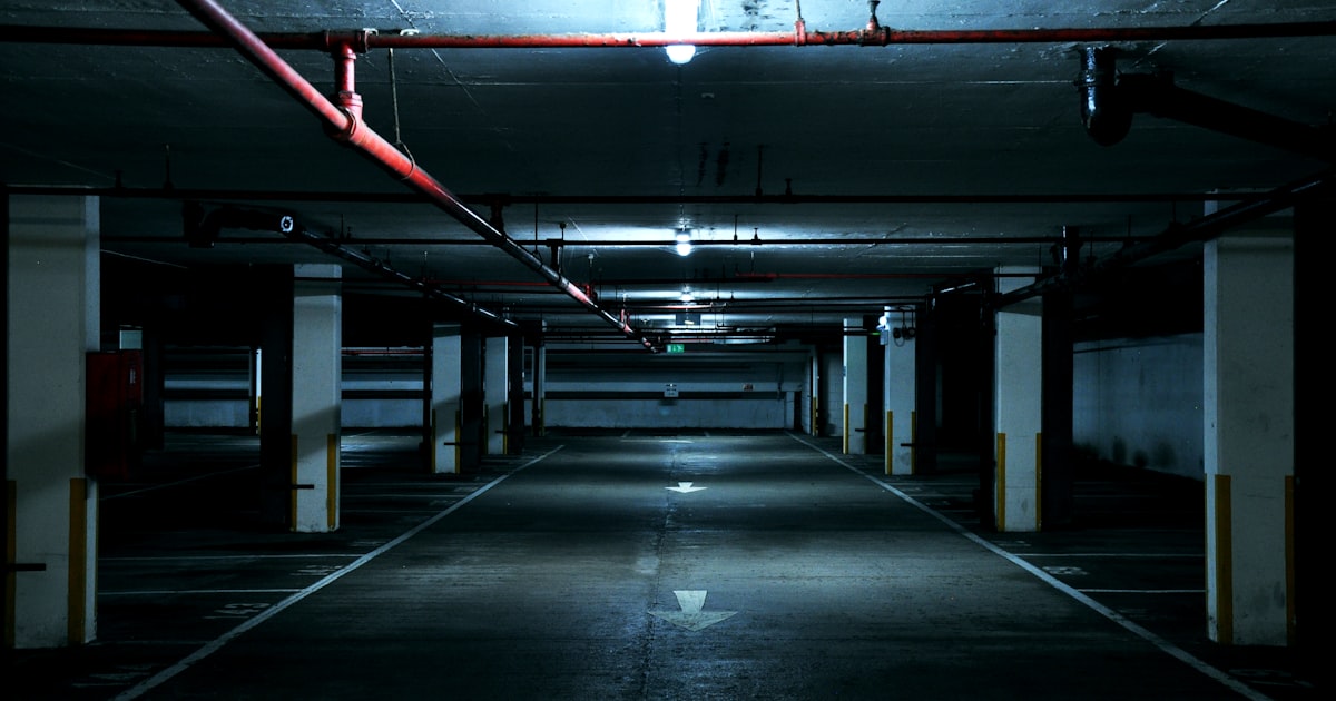 An apartment building entrance at dusk with an unsecured door, illustrating the access control failures at the center of many negligent security cases