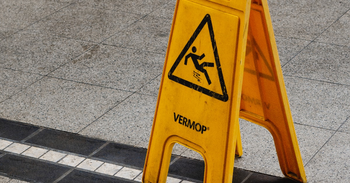 A caution sign warning of a slippery walkway at a Cleveland business entrance