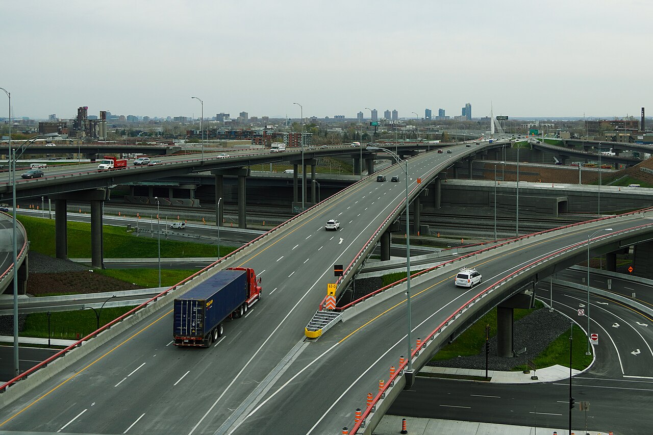Tractor-trailer crossing a highway bridge in heavy traffic