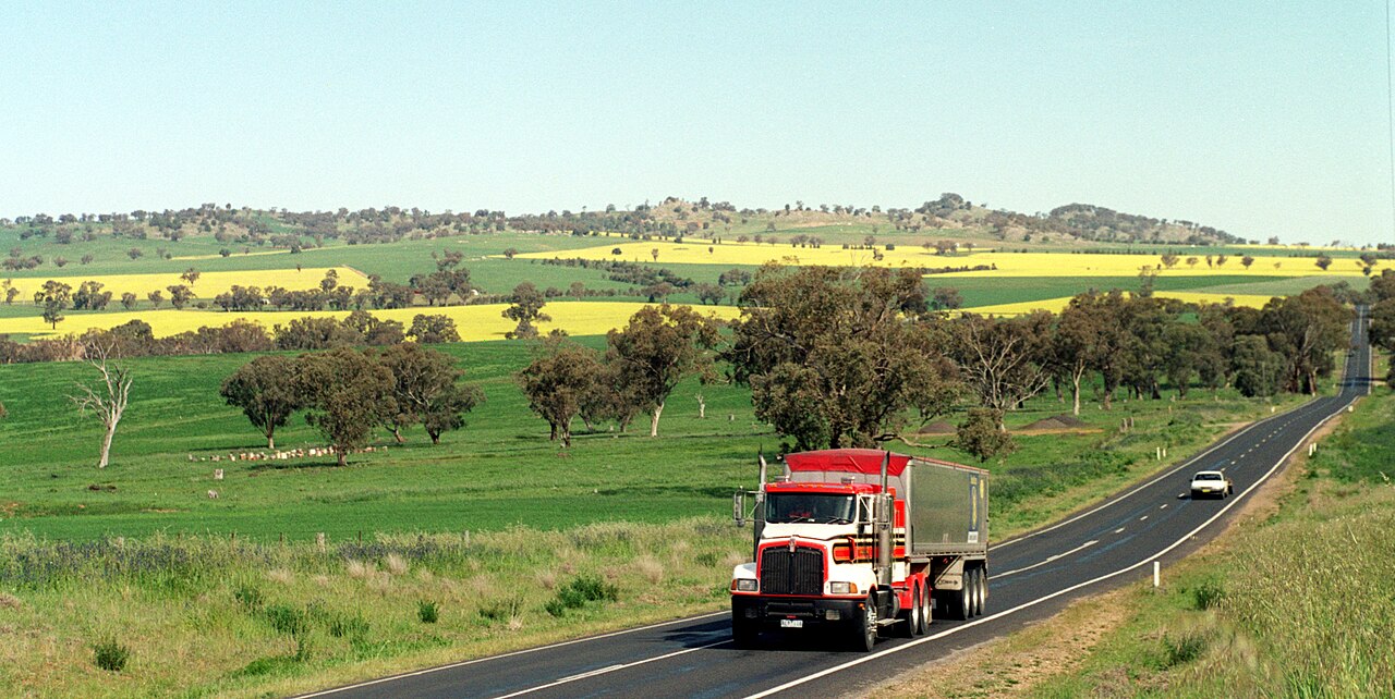 Large commercial truck on a rural highway at dusk