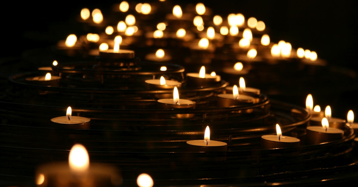 A quiet candle at nightfall symbolizing remembrance and the search for accountability