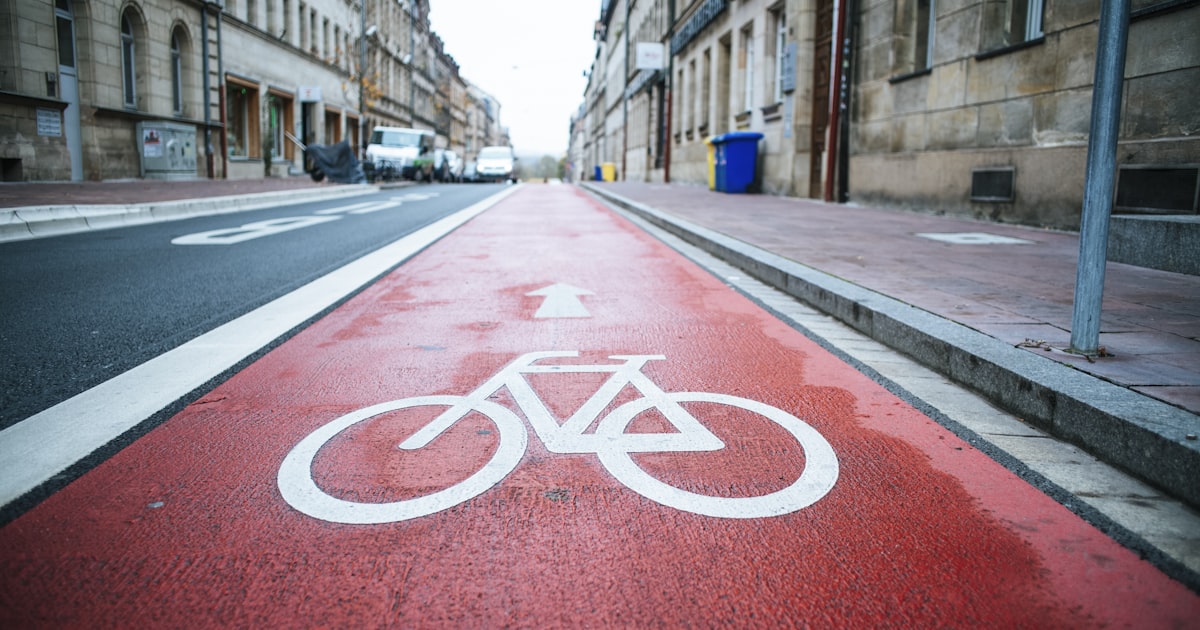 Damaged bicycle resting on pavement after a collision