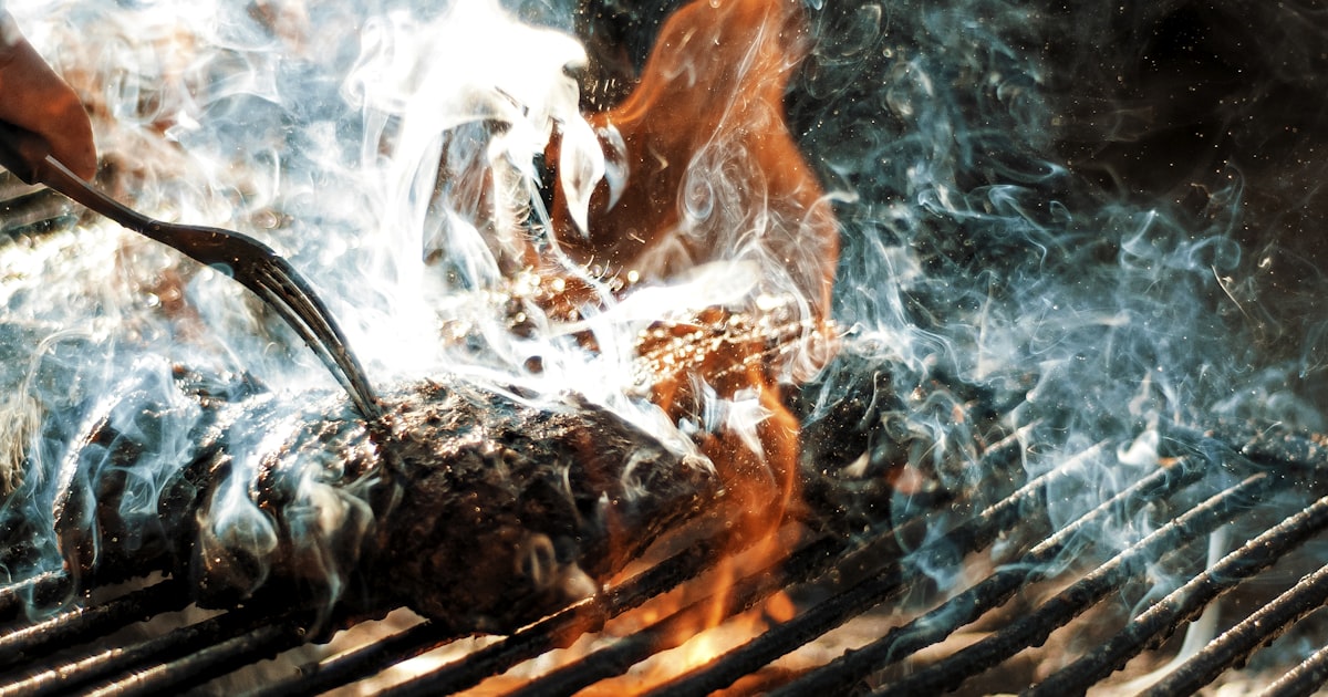 Firefighter using a hose on flames, illustrating a Cleveland house fire response