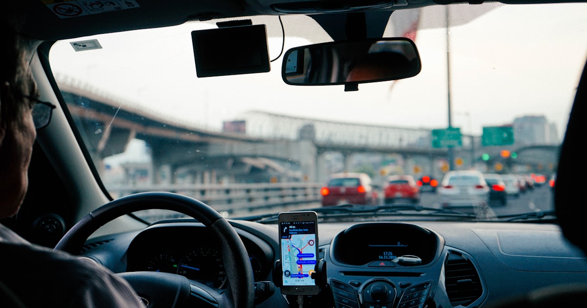 Driver looking at a phone behind the wheel on a Cleveland road