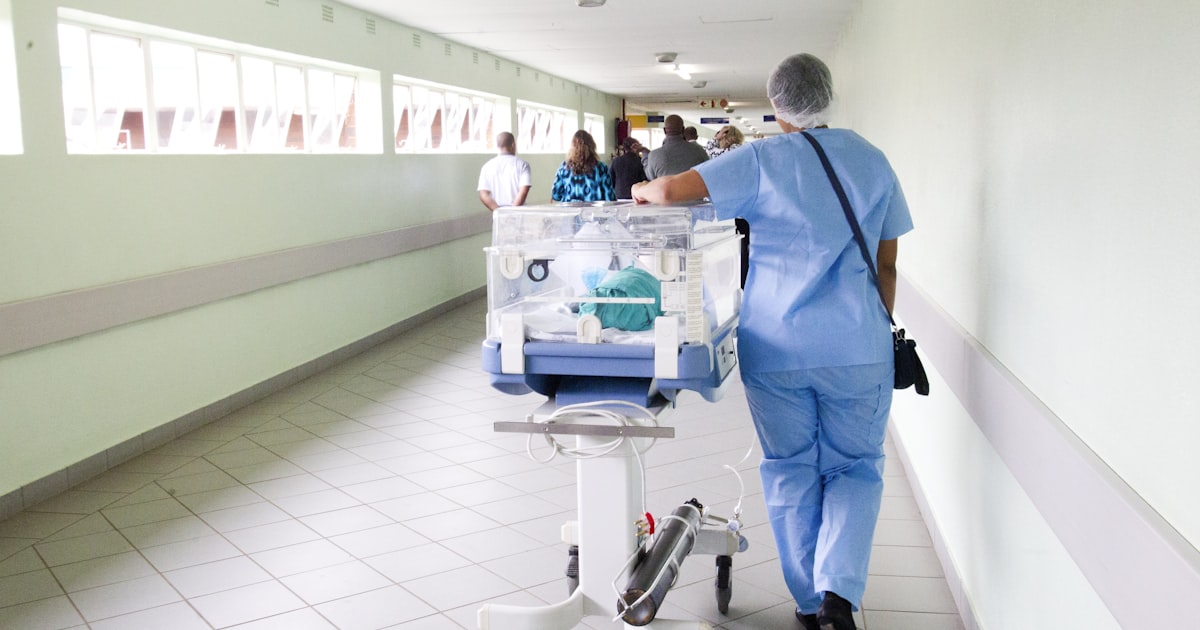 A hospital team reviewing a patient chart, illustrating how communication gaps can lead to medical errors