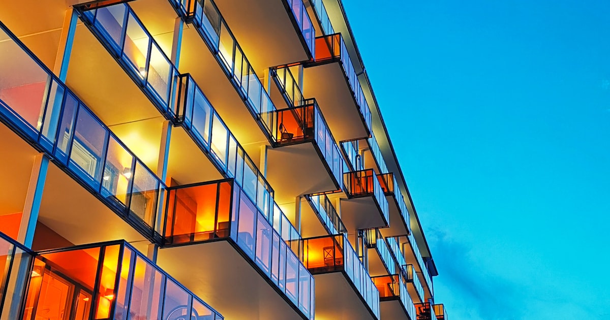Exterior of a multi-unit apartment building lit at night, a common negligent security setting in Greater Cleveland