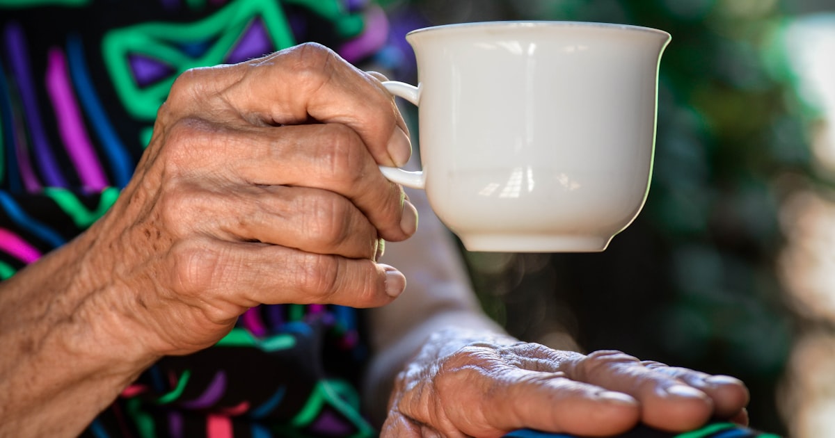 A family member reviewing care documents with an older relative at a nursing home