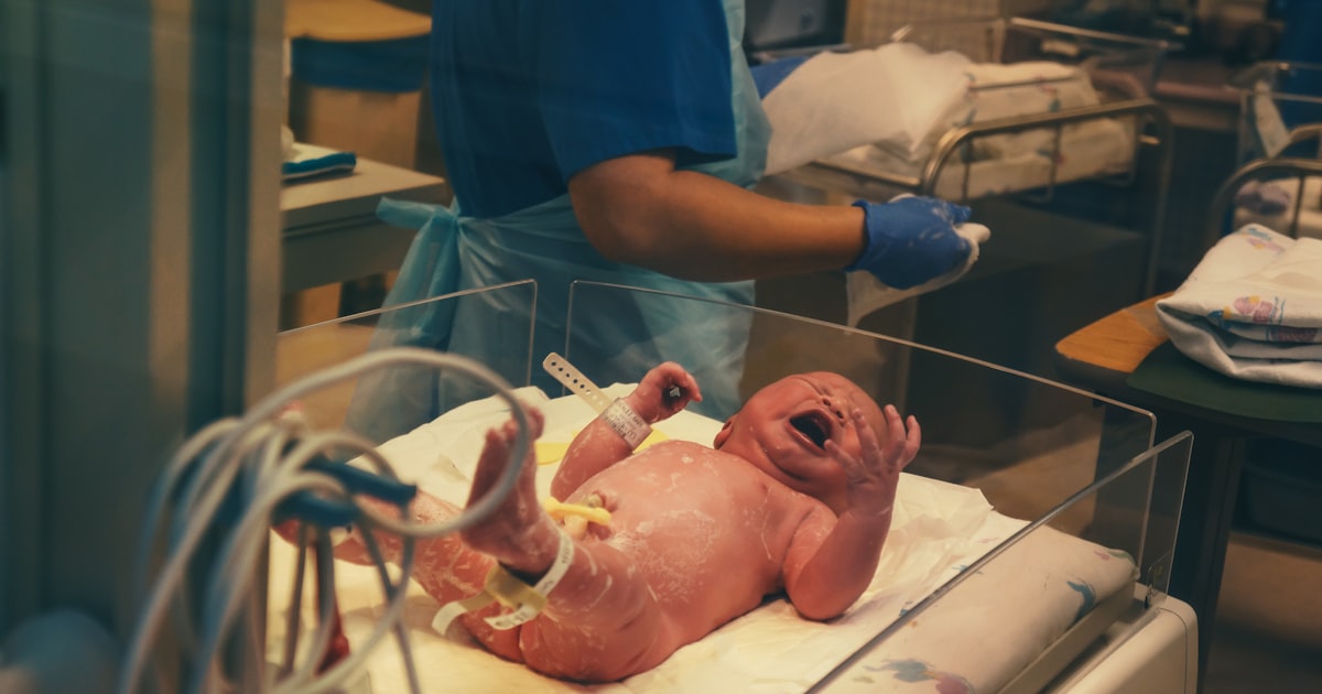Nurse monitoring a newborn in a Northeast Ohio hospital, illustrating fetal and infant monitoring