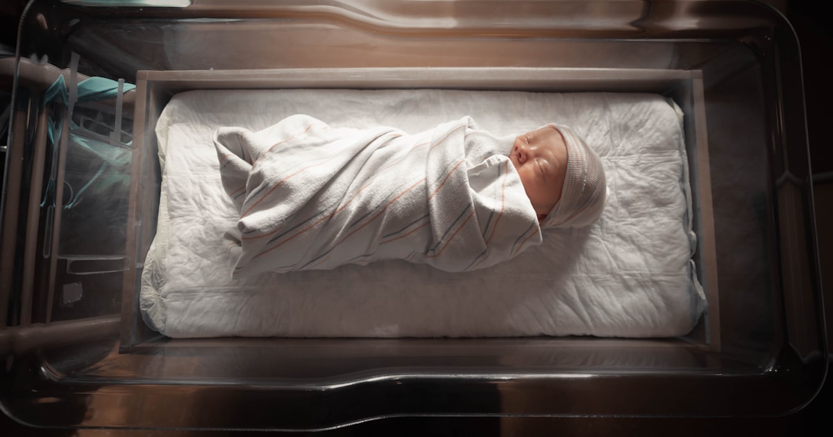 Parent holding a newborn's hand, representing a Cleveland family caring for a child with a birth injury