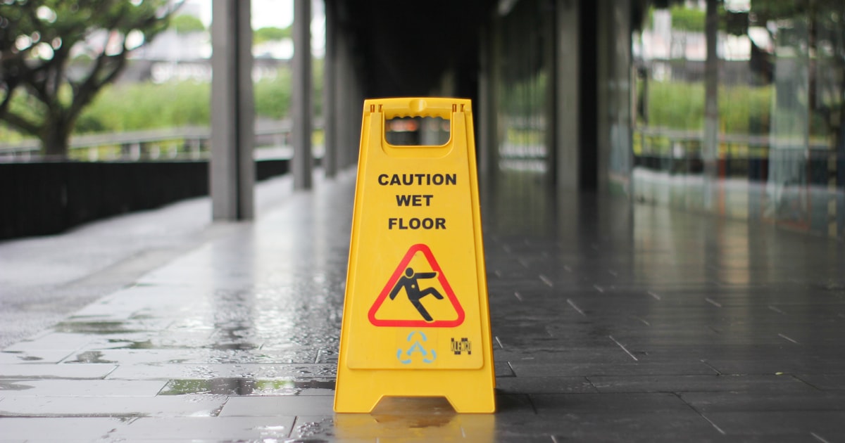 Yellow wet floor caution sign warning of a slip hazard