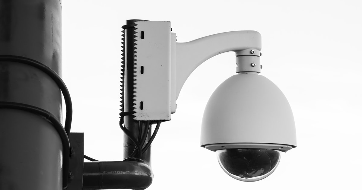 Security camera overlooking a dim parking area where negligent security injuries often occur