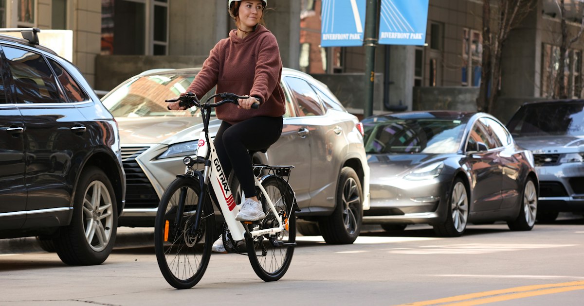 A cyclist riding through a Cleveland intersection in low evening light