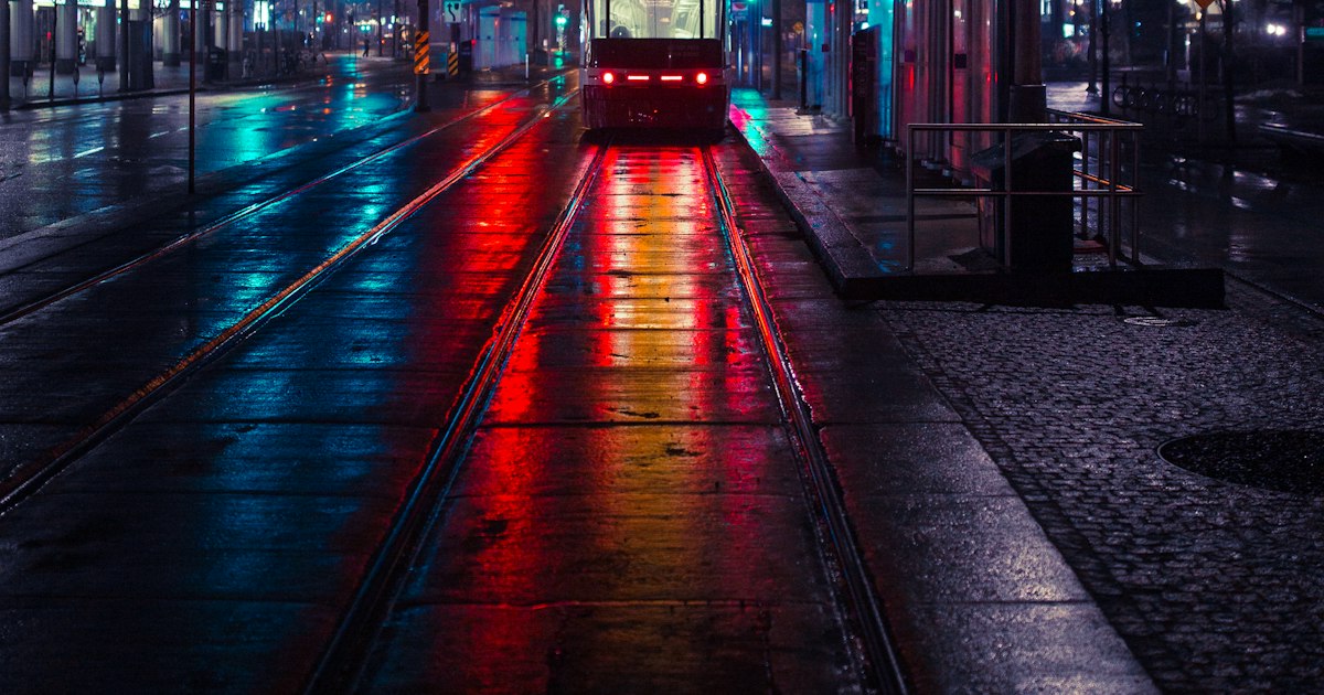 Headlights on a wet city street after dark in autumn