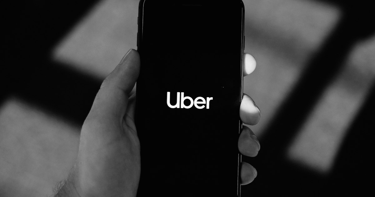 A rideshare passenger checking a ride on a smartphone app