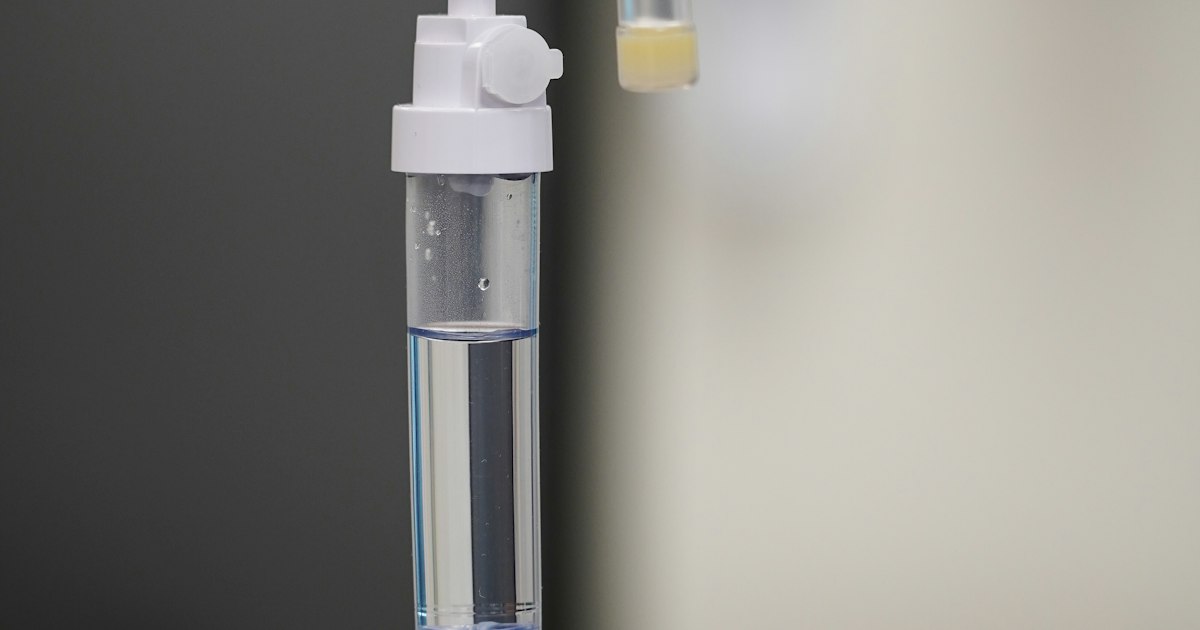 A nurse tends an IV line, a reminder that sepsis survival depends on fast fluids and antibiotics