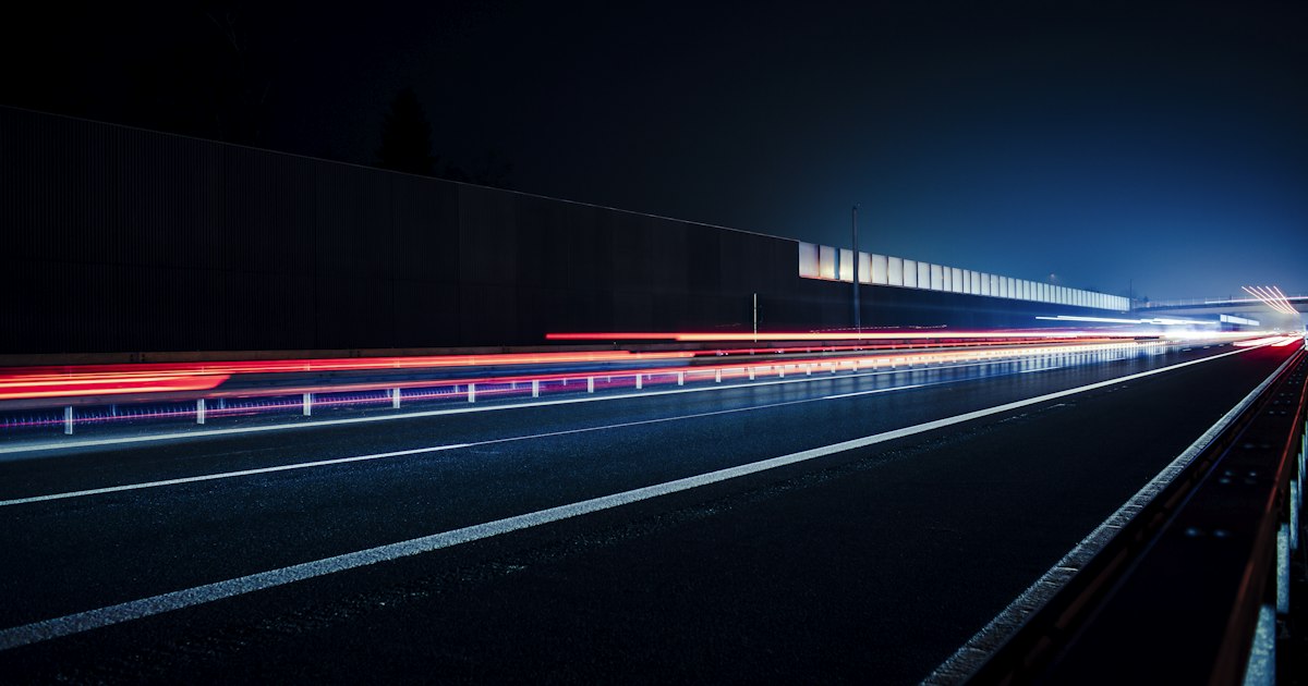 Taillights streaking along a wet Cleveland road after dark