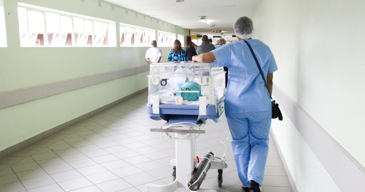 A patient monitor beside a hospital bed, one of the networked systems an attack can disable