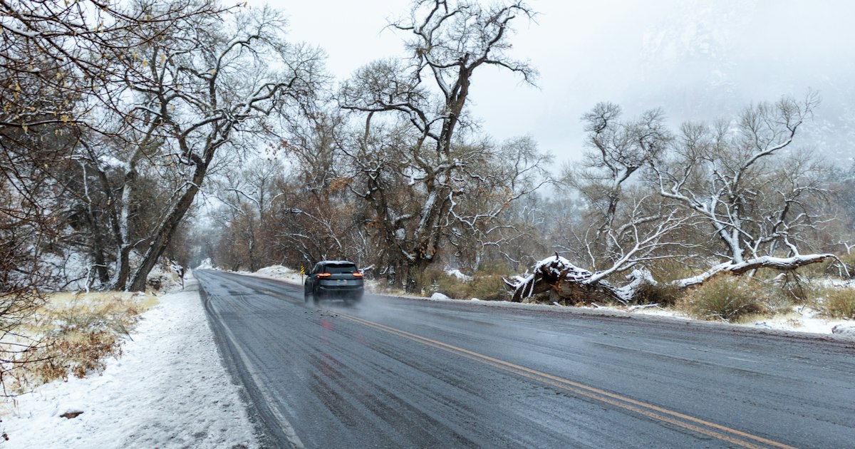 A car travels a wet, snow covered Ohio road during winter driving conditions