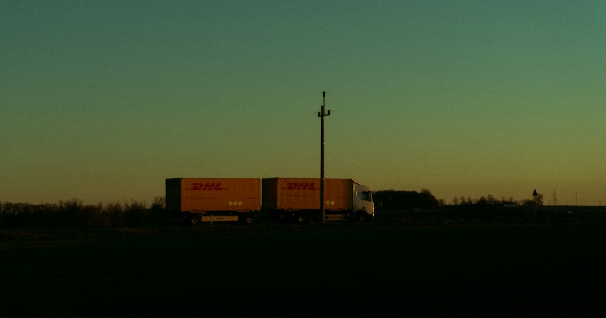 A semi-truck silhouetted against a fall twilight sky on an Ohio interstate