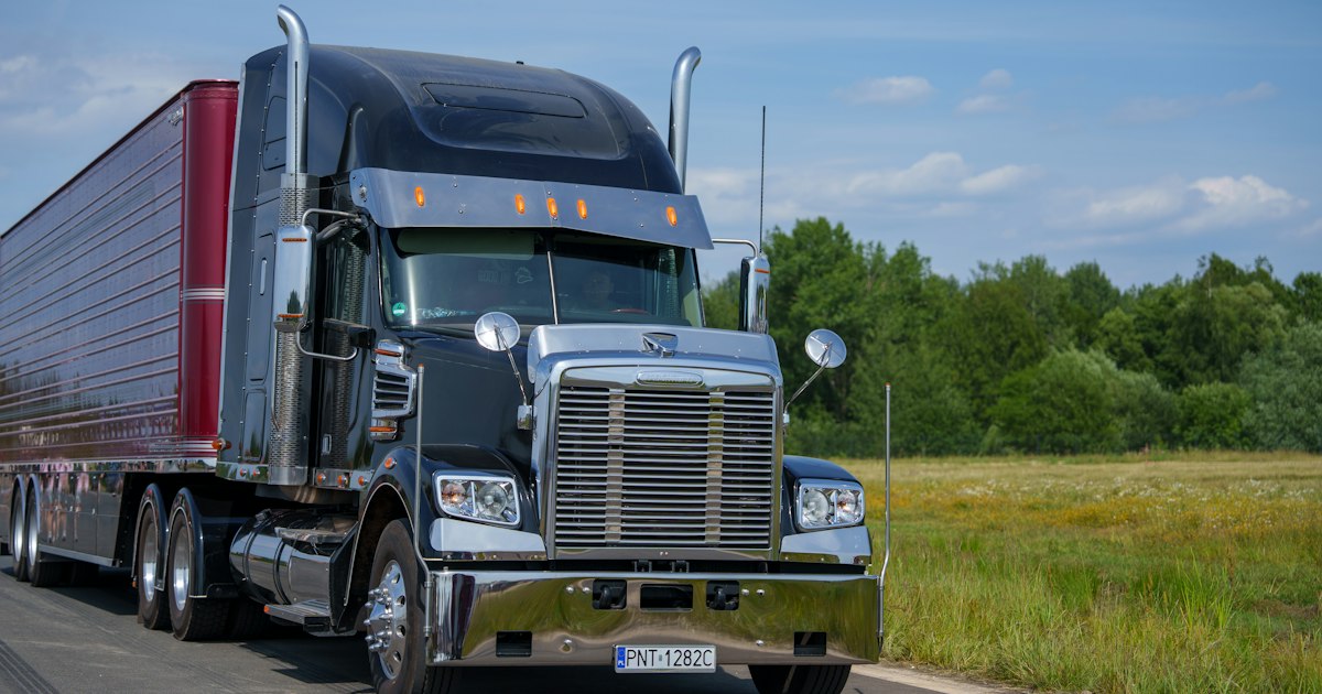 A heavy commercial semi-truck on an open highway, the kind of rig that travels Cleveland interstates each day