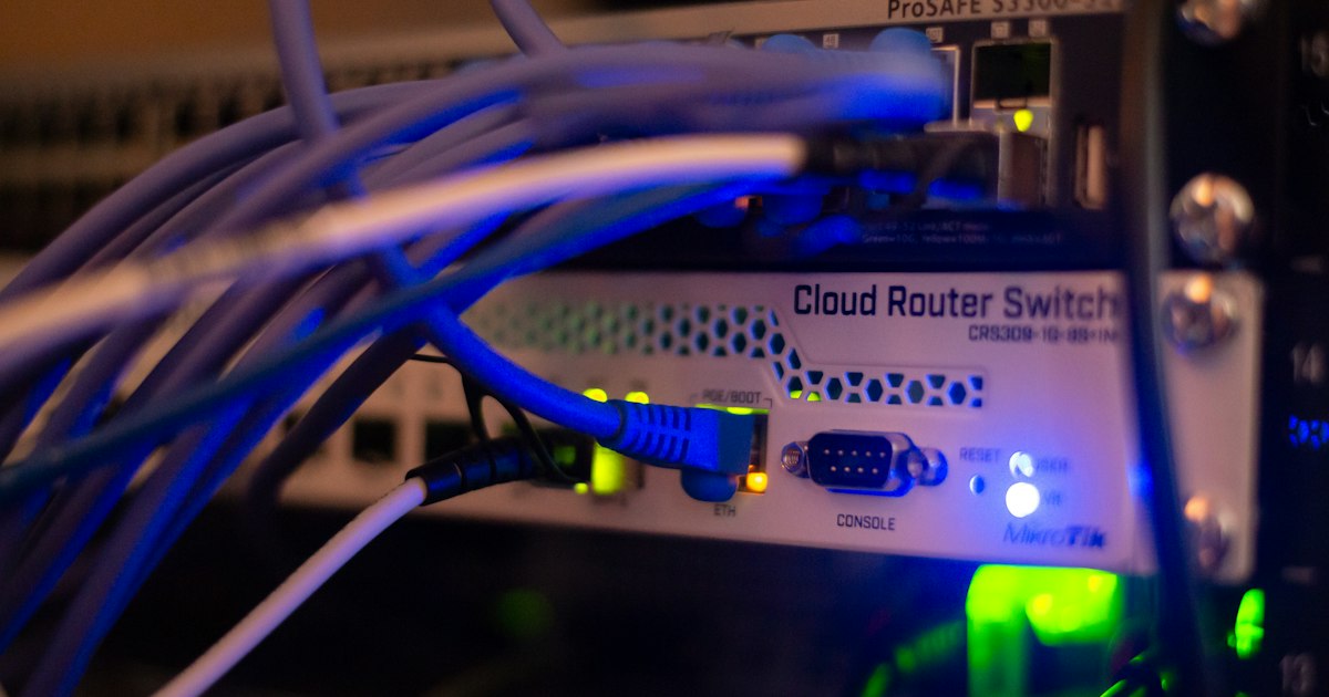 Blue lines of code on a dark screen, the digital layer behind modern hospital care